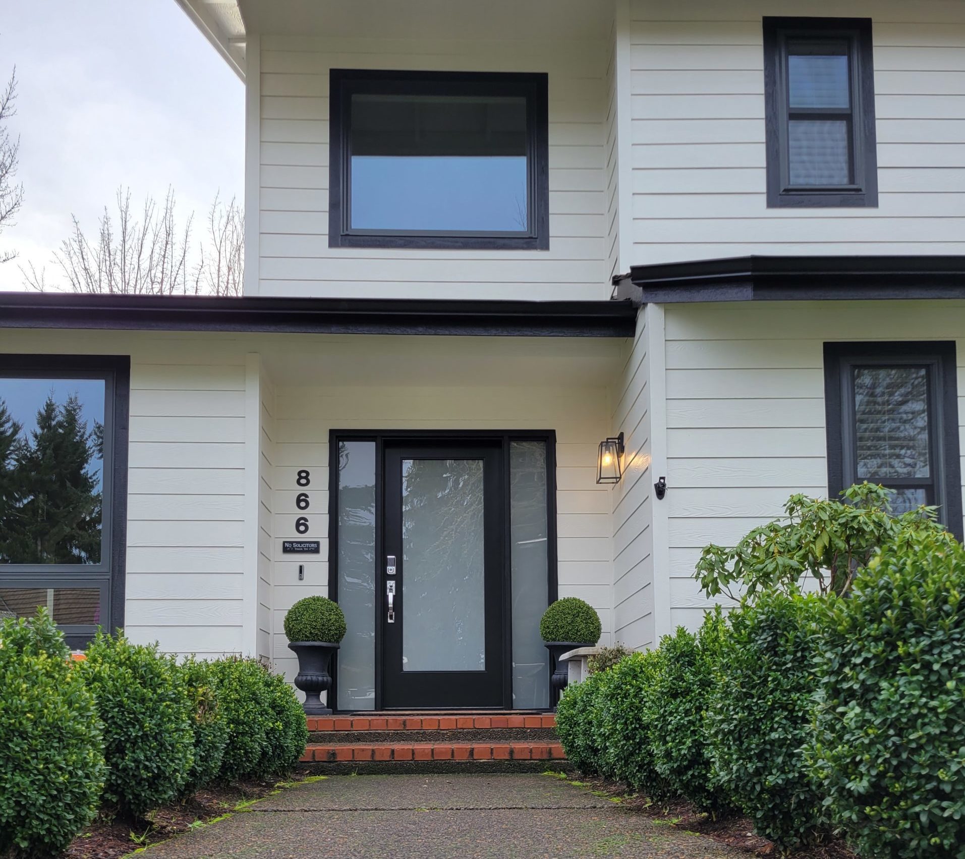 Clean and kept home with modern black windows and doors.