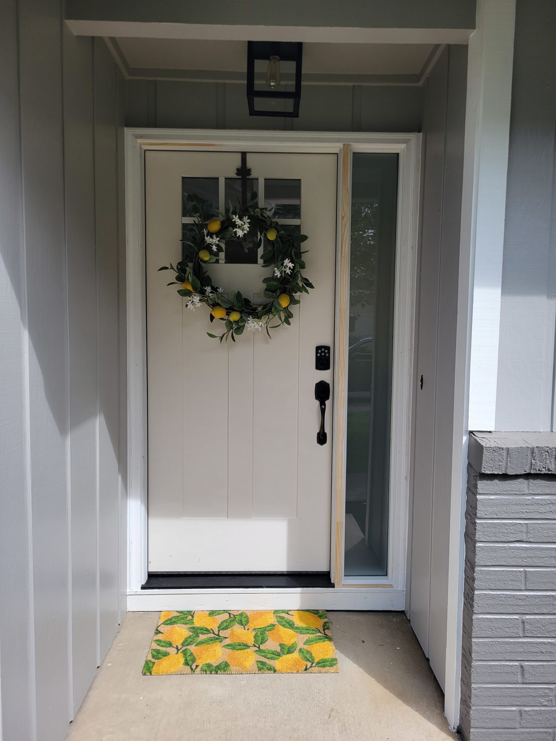 New Front Door with Lemon Themed wreath and doormat.